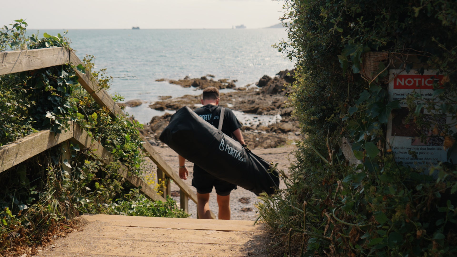 Carrying PortaSauna HEX down beach stairs