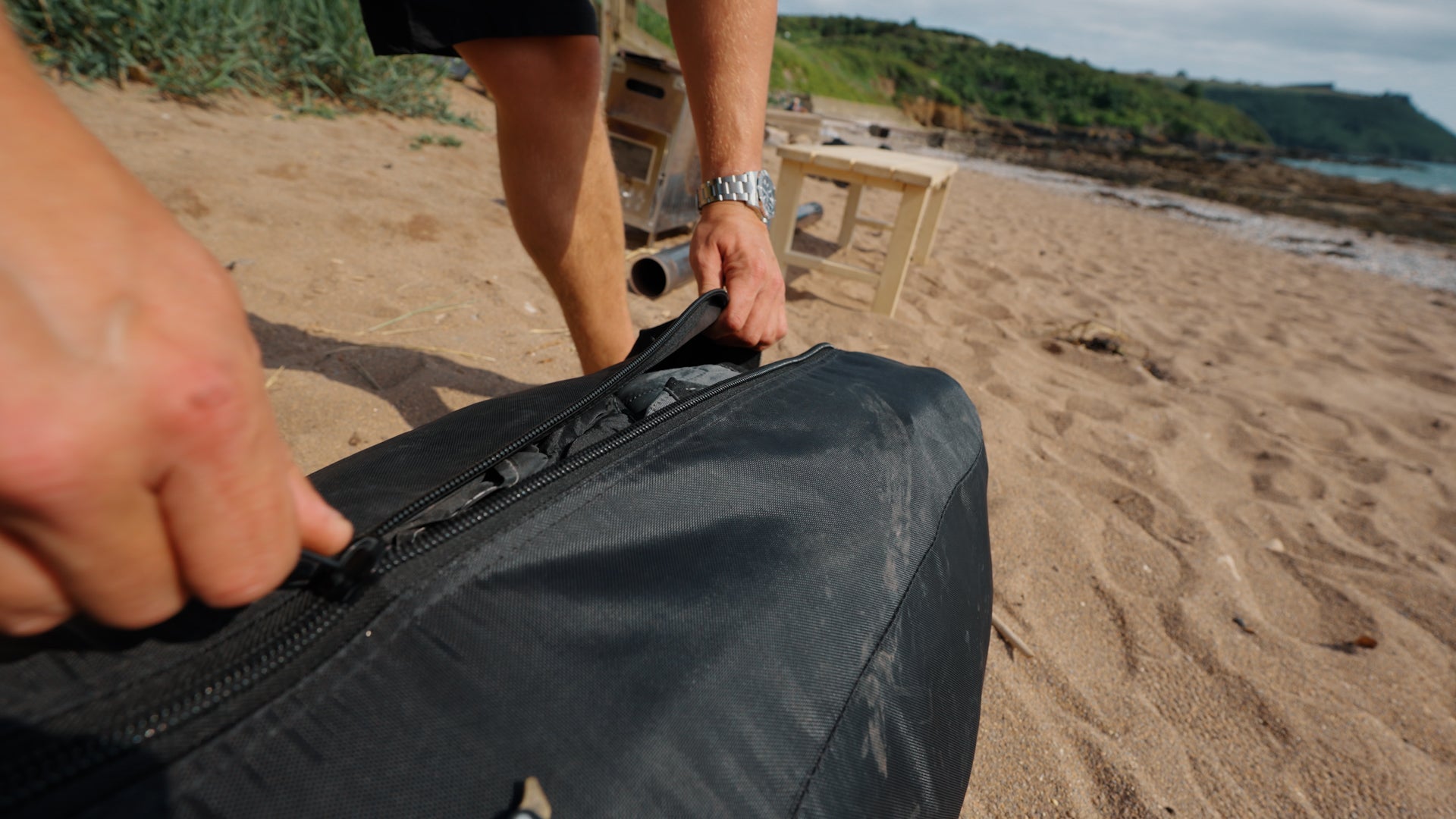 PortaSauna HEX bags stacked on the sand
